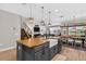 Open-concept kitchen features an island with a farmhouse sink, wooden countertop, view of the dining area, and Gathering room at 7570 Sweeter Tide Trl, Wesley Chapel, FL 33545