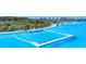 Picturesque view of community's lagoon featuring clear blue water, docks, and fun watercraft for residents at 7570 Sweeter Tide Trl, Wesley Chapel, FL 33545
