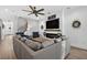 Cozy living room with a shiplap accent wall, fireplace, comfortable seating, and hardwood floors for relaxation and style at 7570 Sweeter Tide Trl, Wesley Chapel, FL 33545