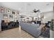 Inviting living room boasts an open floor plan, modern decor, and seamlessly connects to the dining area and kitchen at 7570 Sweeter Tide Trl, Wesley Chapel, FL 33545