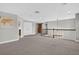Open loft area featuring neutral walls, carpeted flooring, and a wrought iron railing overlooking the lower level at 7570 Sweeter Tide Trl, Wesley Chapel, FL 33545