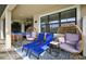 Covered patio featuring outdoor seating, lounge chairs, and brick floors at 7570 Sweeter Tide Trl, Wesley Chapel, FL 33545