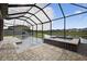 Screened-in pool featuring hot tub, water feature, paver patio, and lake view at 7570 Sweeter Tide Trl, Wesley Chapel, FL 33545