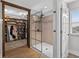Modern bathroom shower with glass enclosure, walk-in closet, neutral tile, and modern fixtures at 7570 Sweeter Tide Trl, Wesley Chapel, FL 33545