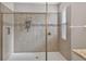 Spa-like walk-in shower featuring modern tilework, a rainfall showerhead, a built-in niche, and a glass enclosure at 7570 Sweeter Tide Trl, Wesley Chapel, FL 33545