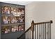 Stylish staircase with modern railing, custom lighting, and Gathering pictures adding a personal touch to the home's decor at 7570 Sweeter Tide Trl, Wesley Chapel, FL 33545