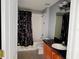 Full bathroom with shower and tub combination, tile flooring, modern lighting, and a single vanity at 7705 Nottinghill Sky Dr, Apollo Beach, FL 33572