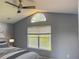 Bright bedroom featuring large windows that provide ample natural light, and modern ceiling fan at 7705 Nottinghill Sky Dr, Apollo Beach, FL 33572