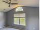 Bedroom with large window allowing plenty of natural light, and ceiling fan at 7705 Nottinghill Sky Dr, Apollo Beach, FL 33572