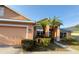 Charming single Gathering home featuring a two car garage, lush landscaping, and a sidewalk entrance at 7705 Nottinghill Sky Dr, Apollo Beach, FL 33572