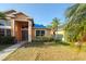 Beautiful single Gathering home with manicured lawn and mature palm trees, offers great curb appeal at 7705 Nottinghill Sky Dr, Apollo Beach, FL 33572
