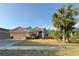 Charming single Gathering home with lush landscaping and mature palm trees, offers great curb appeal at 7705 Nottinghill Sky Dr, Apollo Beach, FL 33572