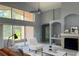 Bright living room boasts vaulted ceilings, fireplace, and large sliding glass doors to the lanai at 7705 Nottinghill Sky Dr, Apollo Beach, FL 33572