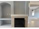 Spacious living room featuring a fireplace and built-in shelving at 7705 Nottinghill Sky Dr, Apollo Beach, FL 33572
