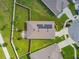 Aerial view showcasing a home's roof with solar panels and a spacious, green backyard at 8174 Wheat Stone Dr, Zephyrhills, FL 33540