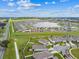 Wide aerial shot of a well maintained community with a beautiful lake and meticulously kept landscaping at 8174 Wheat Stone Dr, Zephyrhills, FL 33540