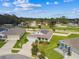 Aerial view of a well maintained one story home with lush landscaping and solar panels, nestled in a manicured neighborhood at 8174 Wheat Stone Dr, Zephyrhills, FL 33540