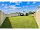 A spacious, well-maintained backyard is enclosed by a fence, offering privacy and room for outdoor activities at 8174 Wheat Stone Dr, Zephyrhills, FL 33540