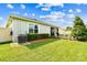 A well-maintained backyard features a lush lawn, a paver patio, and access to a screened-in porch at 8174 Wheat Stone Dr, Zephyrhills, FL 33540
