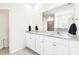 Bathroom boasts double granite-topped vanity and a large mirror above it at 8174 Wheat Stone Dr, Zephyrhills, FL 33540