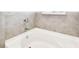 Close-up of a white tiled-in bathtub at 8174 Wheat Stone Dr, Zephyrhills, FL 33540