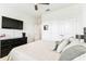 Bedroom with carpeted floor, ceiling fan, TV, and closet at 8174 Wheat Stone Dr, Zephyrhills, FL 33540