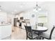 Bright dining area features tile floors, white cabinets and stainless appliances at 8174 Wheat Stone Dr, Zephyrhills, FL 33540