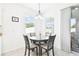 Cozy dining area with natural light and a modern chandelier at 8174 Wheat Stone Dr, Zephyrhills, FL 33540