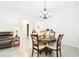 Bright dining room featuring a round table, four chairs, and an elegant chandelier at 8174 Wheat Stone Dr, Zephyrhills, FL 33540