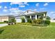 Beautiful single Gathering home with a two car garage and lush landscaping at 8174 Wheat Stone Dr, Zephyrhills, FL 33540