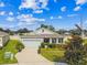 Charming one-story home with a well-manicured lawn, vibrant flowerbeds, and a convenient two-car garage at 8174 Wheat Stone Dr, Zephyrhills, FL 33540