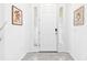 Bright entryway featuring a white door with sidelights and neutral tile flooring at 8174 Wheat Stone Dr, Zephyrhills, FL 33540