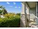 Comfortable front porch with stone-clad columns and relaxing seating overlooking lush landscaping at 8174 Wheat Stone Dr, Zephyrhills, FL 33540