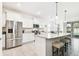 Bright kitchen with granite countertops, stainless steel appliances, and an island with bar seating at 8174 Wheat Stone Dr, Zephyrhills, FL 33540