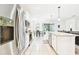 Bright and spacious kitchen, features stainless steel appliances, granite countertops, and modern white cabinetry at 8174 Wheat Stone Dr, Zephyrhills, FL 33540