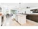 Kitchen island featuring granite countertops and stainless steel appliances, with views of the living and dining areas at 8174 Wheat Stone Dr, Zephyrhills, FL 33540