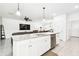 Kitchen island with granite counters overlooks an open floor plan leading to a large living space at 8174 Wheat Stone Dr, Zephyrhills, FL 33540