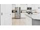 Bright kitchen features stainless steel appliances and white cabinets at 8174 Wheat Stone Dr, Zephyrhills, FL 33540