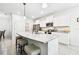 Bright kitchen features granite counters, stainless appliances, and island seating at 8174 Wheat Stone Dr, Zephyrhills, FL 33540