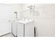 Clean laundry room with washer, dryer, and overhead shelving at 8174 Wheat Stone Dr, Zephyrhills, FL 33540