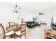 Open-concept living space with a dining area and kitchen featuring modern tile floors and ample lighting at 8174 Wheat Stone Dr, Zephyrhills, FL 33540