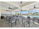 Inviting outdoor seating area with ceiling fans, tables, chairs, and a view of the community pool at 8174 Wheat Stone Dr, Zephyrhills, FL 33540