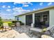 The paver patio features outdoor seating, a grill, and lounge chairs for enjoying the outdoor space at 8174 Wheat Stone Dr, Zephyrhills, FL 33540