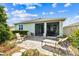 Relaxing patio with lounge chairs and outdoor seating, perfect for enjoying the backyard and screened-in porch at 8174 Wheat Stone Dr, Zephyrhills, FL 33540