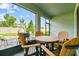 View of screen enclosed patio featuring wooden table and chairs with a view of the backyard and brick patio at 8174 Wheat Stone Dr, Zephyrhills, FL 33540