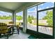 Screen enclosed lanai features an outdoor dining set and views of a brick patio and manicured backyard at 8174 Wheat Stone Dr, Zephyrhills, FL 33540