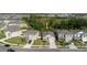 Aerial view of a home and neighborhood with mature trees, showcasing the property's location and surrounding community at 8210 Juning Cv, Wesley Chapel, FL 33545
