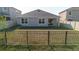 Fenced backyard with grass, a patio, and the rear of the house, offering a private outdoor living space at 8210 Juning Cv, Wesley Chapel, FL 33545