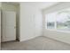 Bright bedroom featuring neutral carpet, fresh white walls, and a window with blinds, offering a clean and serene atmosphere at 8210 Juning Cv, Wesley Chapel, FL 33545