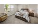 Cozy bedroom with soft carpet, natural light, modern decor, and comfortable furnishings at 8210 Juning Cv, Wesley Chapel, FL 33545